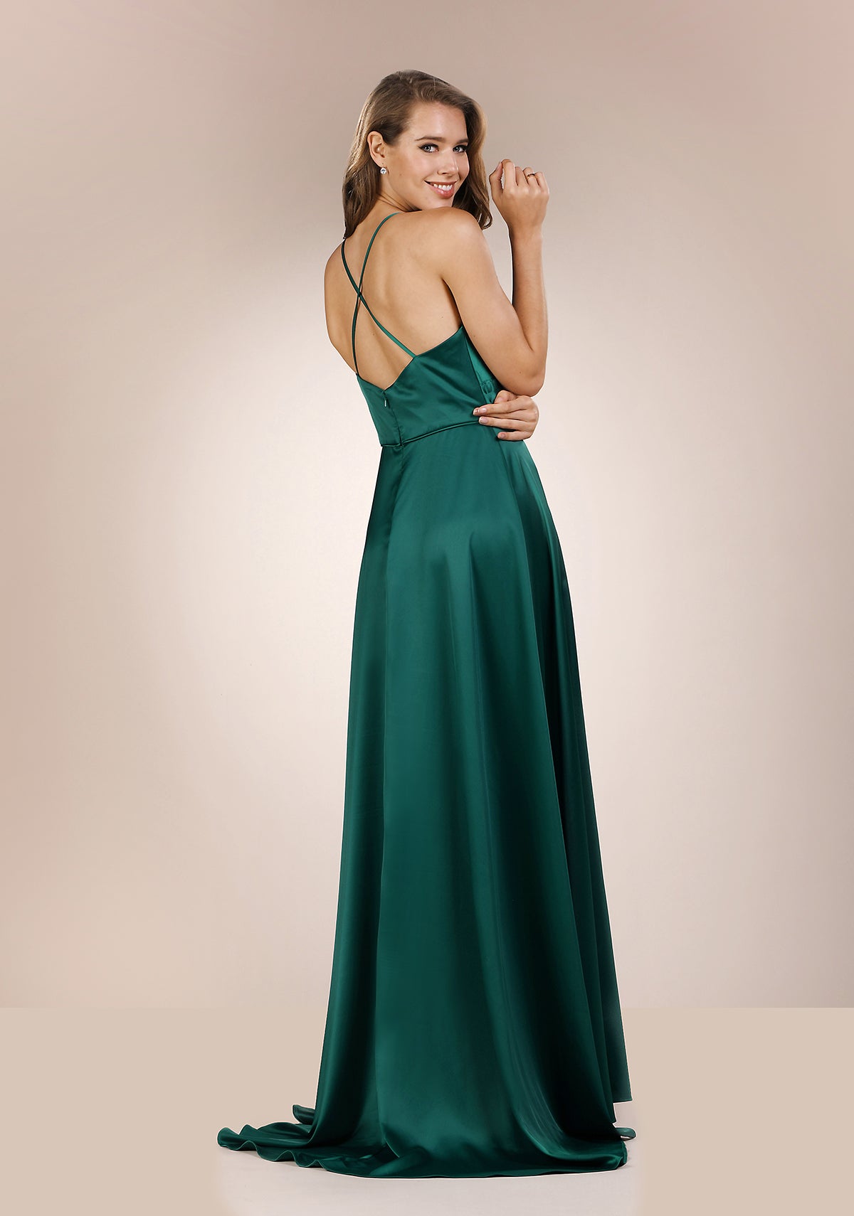 Plain silk green prom dress. Detailed cross over back. Emerald green prom and evening dress with leg slit.